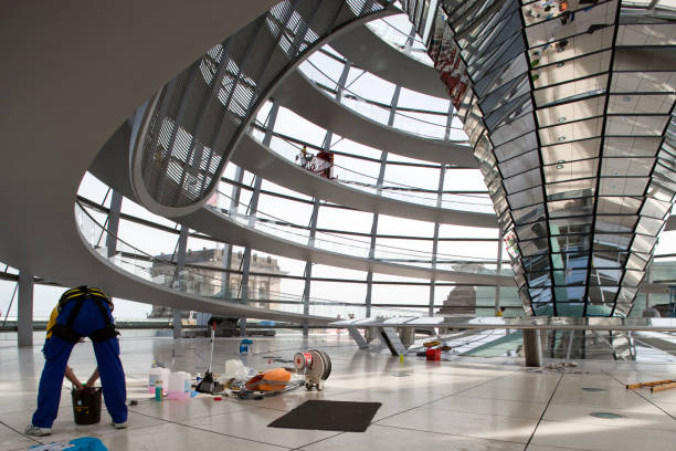 Berlin, Germany, July 27 2009, Workers are cleaning the modern glass roof dome of the Reichstag building in Berlin, showcasing its unique architectural design.